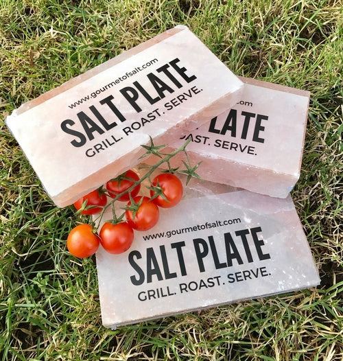 Three salt plates with tomatoes on a grassy background