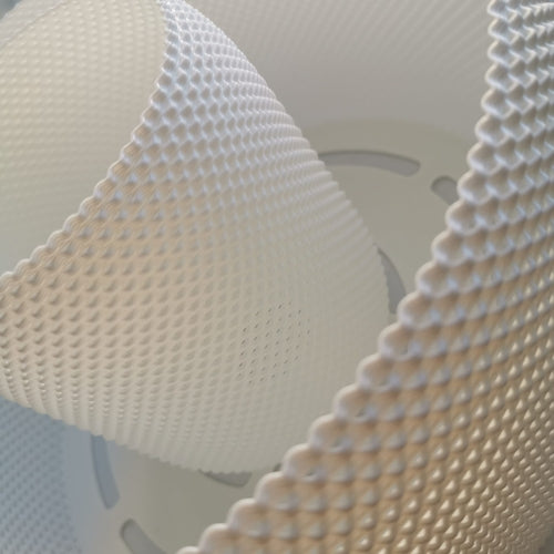 Close-up of a textured white surface with a geometric pattern