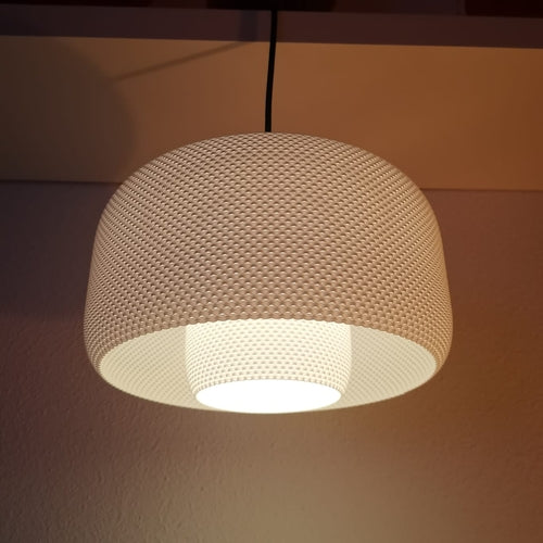 Textured pendant light hanging against a plain background