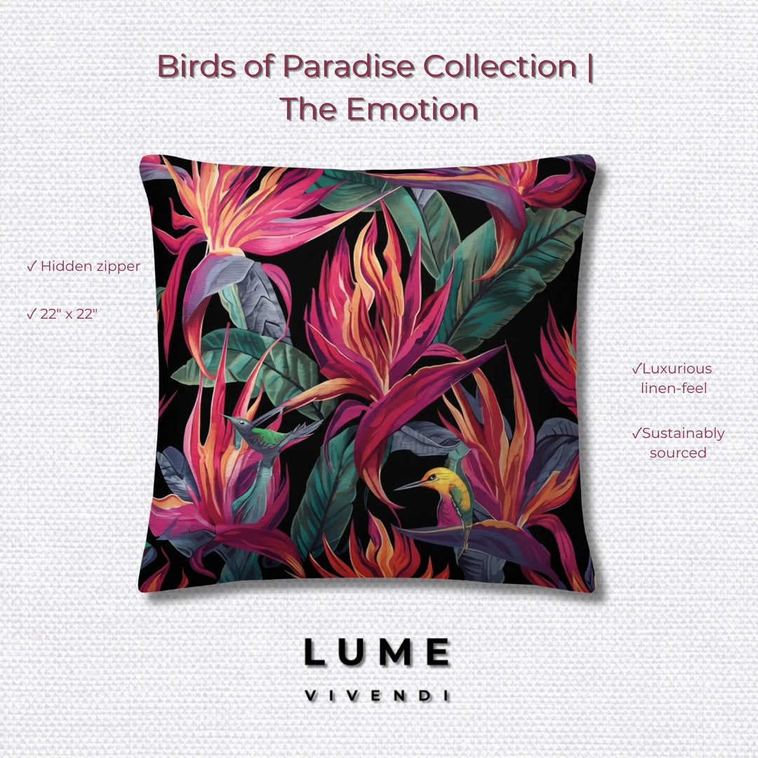 A square decorative throw pillow from the Birds of Paradise Collection by Lume Vivendi, featuring a vibrant tropical floral print with pink, orange, and green leaves on a black background, with a small yellow bird. The pillow is displayed on a light gray textured background with product details and branding text.