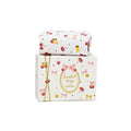 A 100g bar of Cherry Bloom scented soap by SoapTales, presented in a luxury white gift box featuring illustrations of red cherries, pink bows, and delicate gold details.