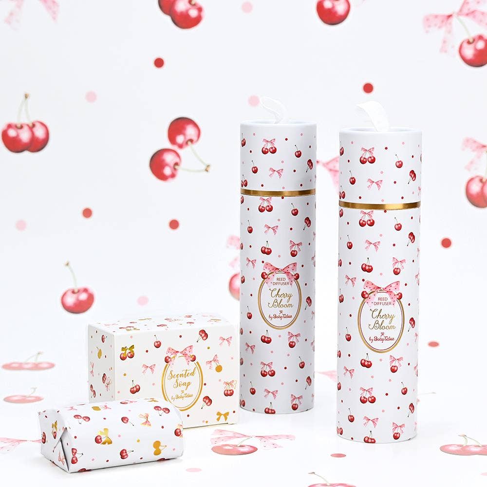 Cherry Bloom scented soap and diffuser by SoapTales, presented in a luxury white gift box featuring illustrations of red cherries, pink bows, and delicate gold details.