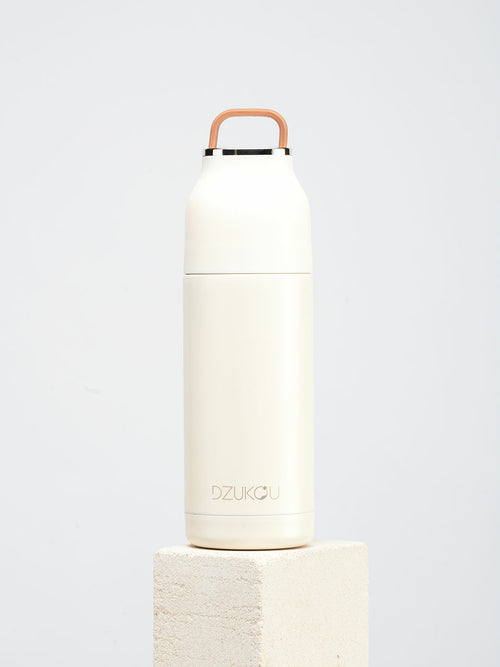 White insulated bottle with brown handle on a light gray background