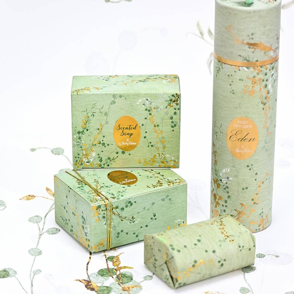 SoapTales Eden scented and diffusersoap in a luxury sage-green gift box decorated with delicate gold vine illustrations and gold foil details.