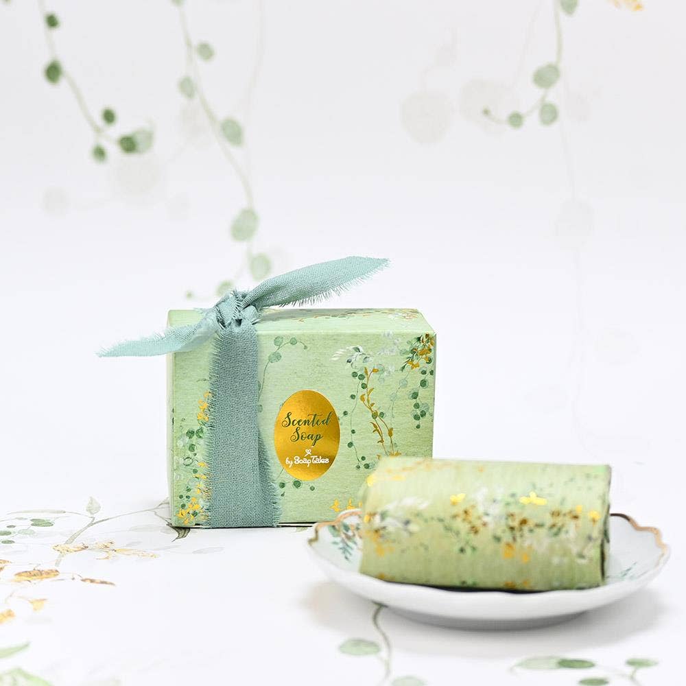SoapTales Eden scented soap in a luxury sage-green gift box decorated with delicate gold vine illustrations and gold foil details.