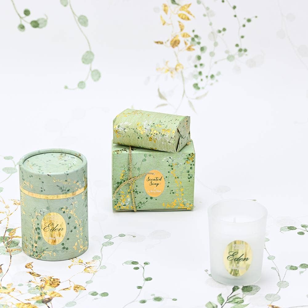 SoapTales Eden scented soap and candle in a luxury sage-green gift box decorated with delicate gold vine illustrations and gold foil details.