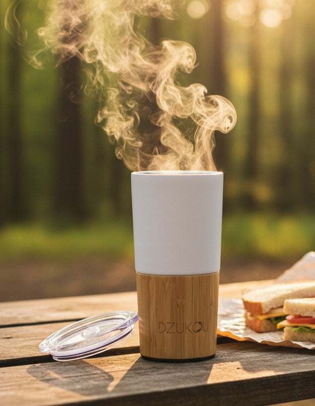 Inca Trail Premium bamboo and stainless steel coffee tumbler 470ml - eco-friendly insulated travel mug with double-wall insulation - ona a wooden table in outdoors
