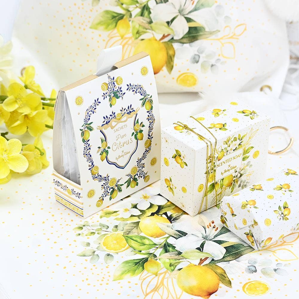 Decorative soap boxes with lemon and floral designs on a white background