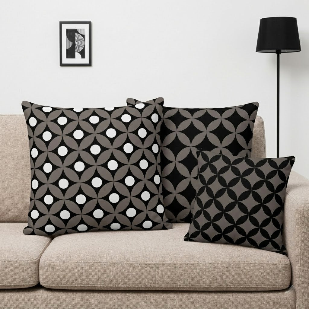 Decorative pillows from Mid-Century Modern Geometric Collection by Lume Vivendi with geometric patterns on a beige sofa.