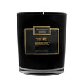 Black candle with gold text on a white background