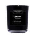 Black candle labeled 'Ceylon' by Treatments on a white background