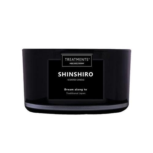 Black scented candle labeled 'Shinshiro' by Treatments on a white background