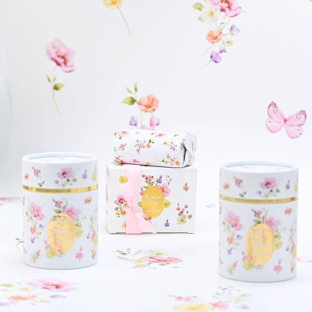Set of decorative tins with floral designs on a white background