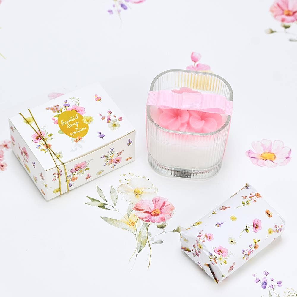 Set of floral soap bars and a candle on a white background