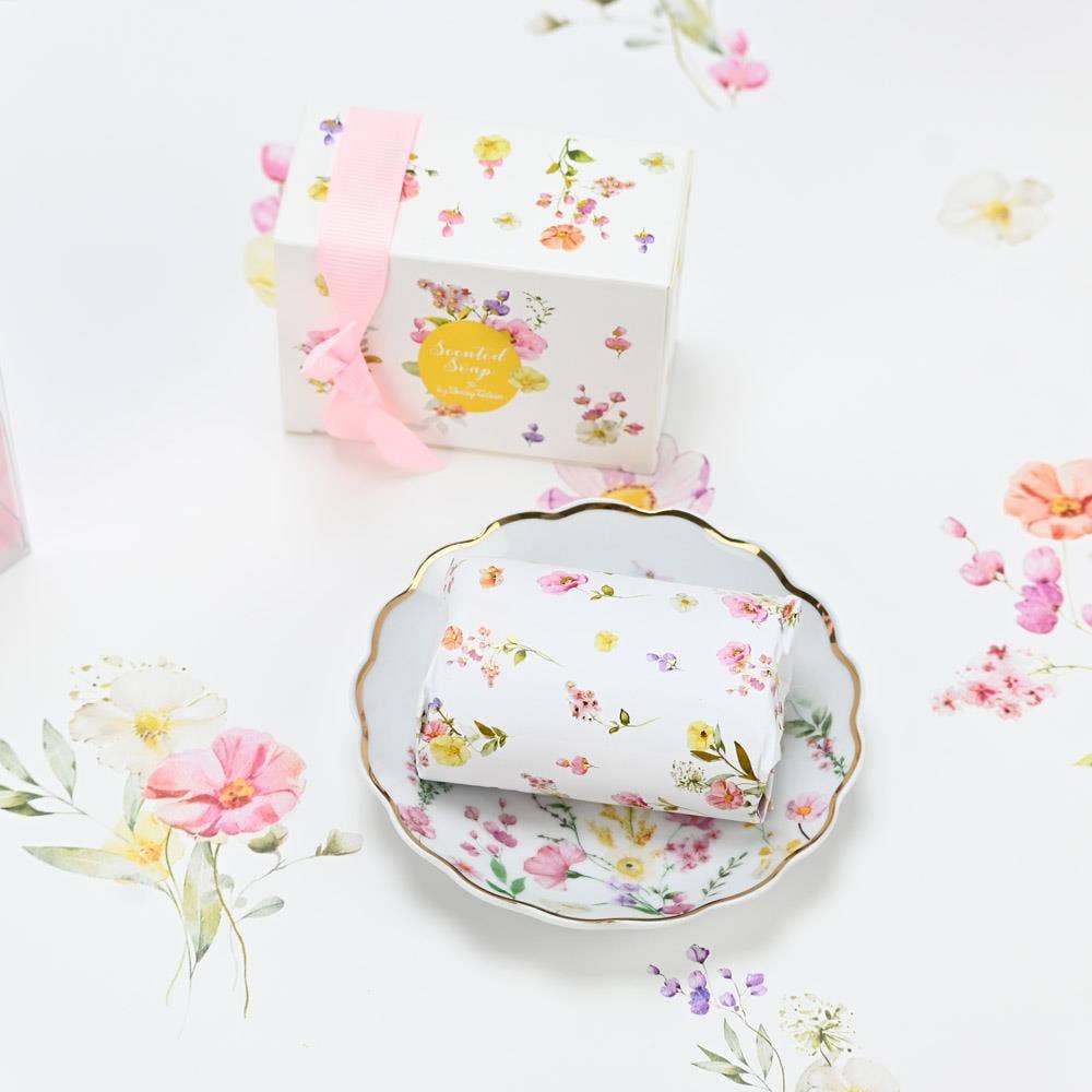 Floral-patterned dish with soap with a matching box on a white background