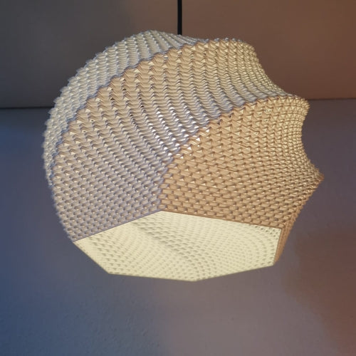 Woven hexagonal lampshade with a geometric pattern on a plain background