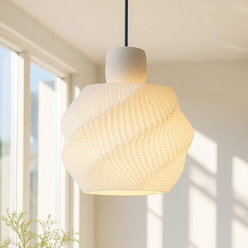 Moder  pendant light hanging in a room with large windows and a plant.