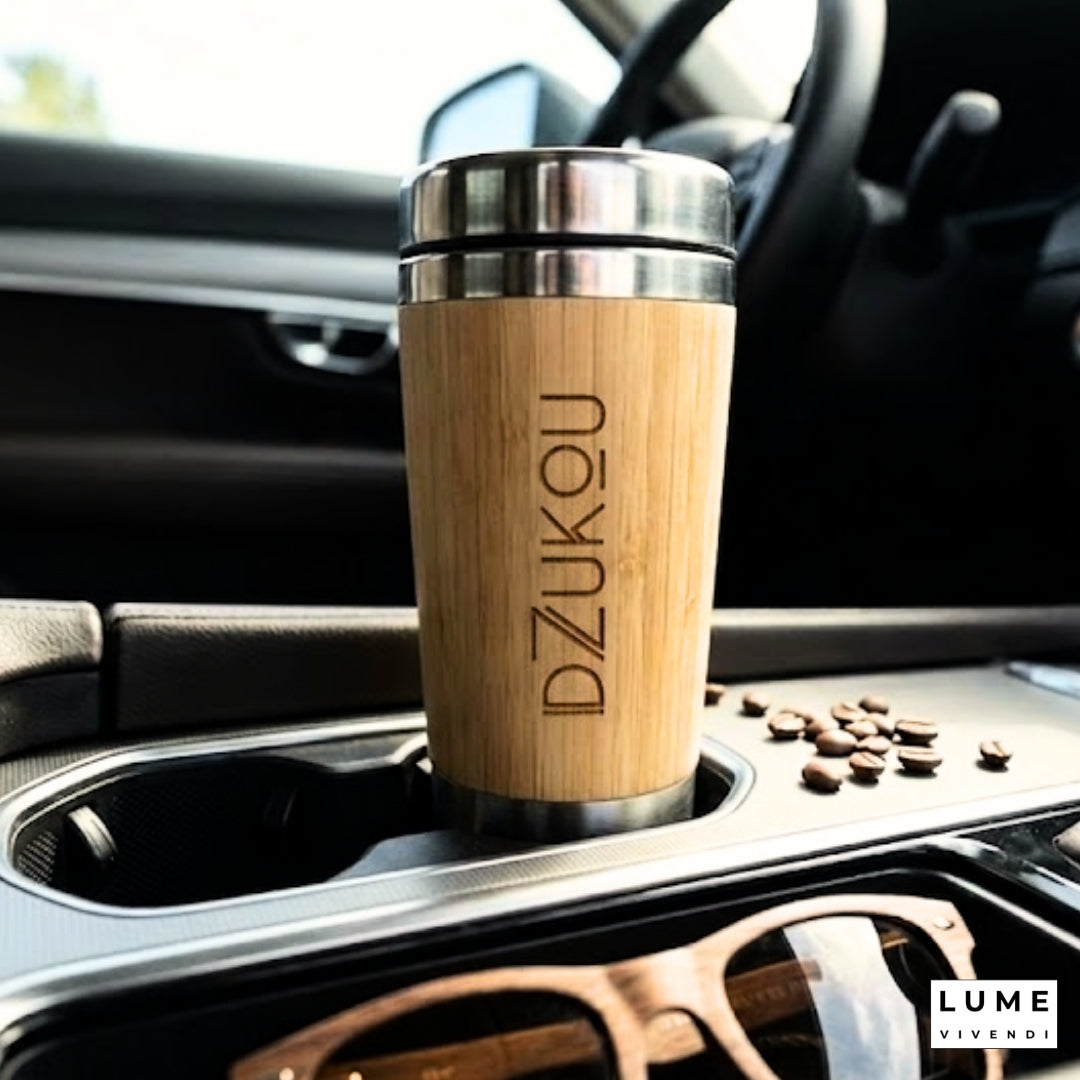 Wooden travel mug with metal lid in a car cup holder, brand 'DZUKOU' visible