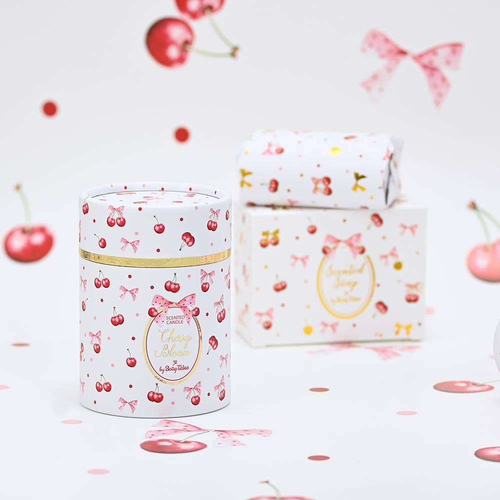 Cherry Bloom candle and soap packaging with cherry and bow design on a light background